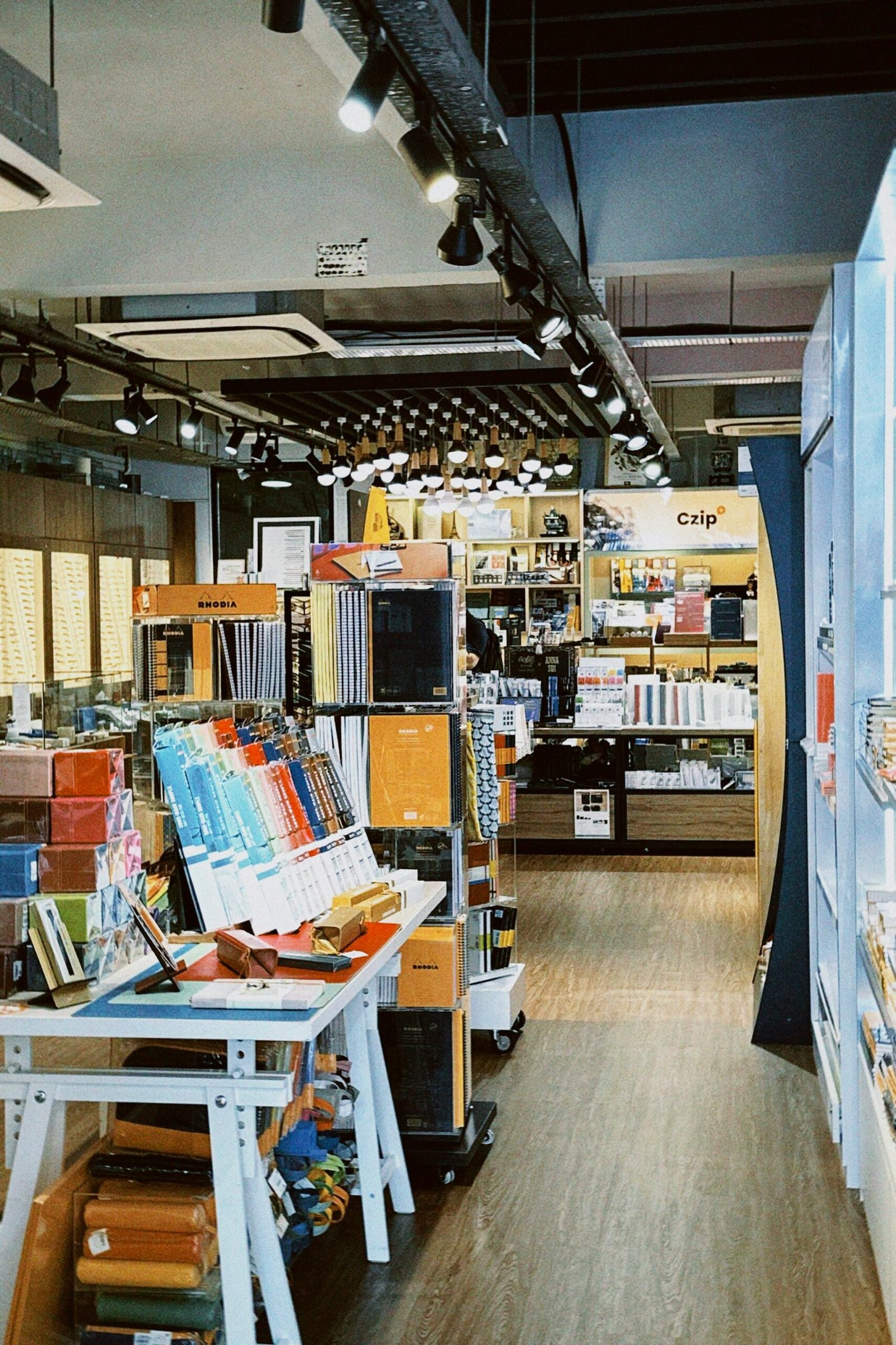 Explore a well-lit bookstore with organized bookshelves and retail displays, perfect for book lovers.